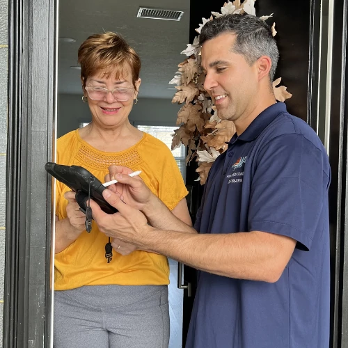 Professional MP+ HVAC technician in uniform repairing a residential outdoor AC unit in Brandon, FL